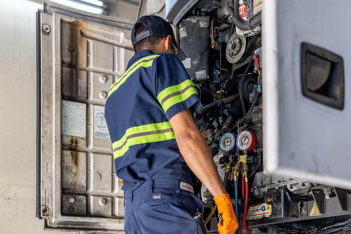 Big Rig Fixer technician reading refrigeration gauges on a trailer reefer unit