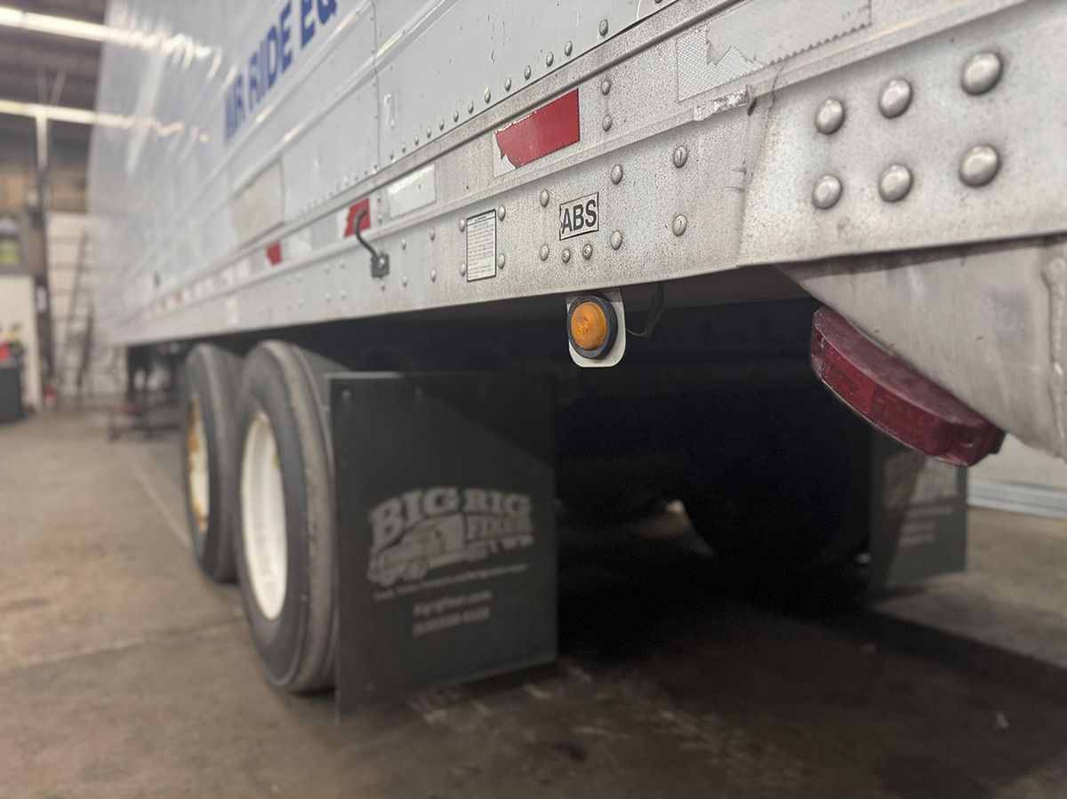 Trailer wheels, side marker light, and ABS indicator in the shop
